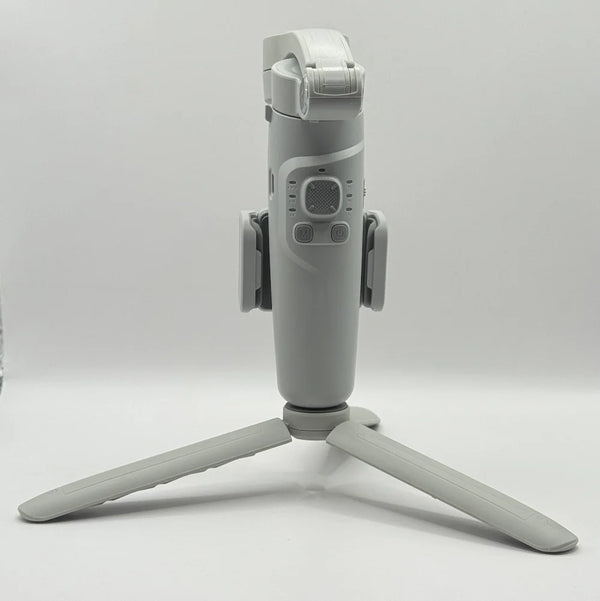Front view of grey Merak One smartphone gimbal showcasing joystick, mode button, power button, and tripod legs