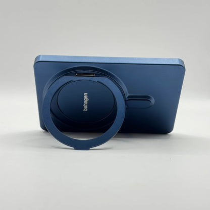Horizontal orientation view of behagen magnetic power bank resting on extended ring stand for landscape media viewing