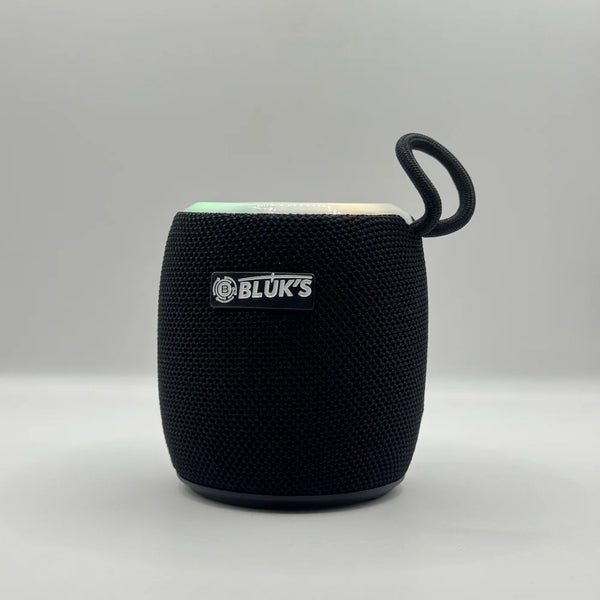 Front perspective of BLUK'S BX-176 black fabric mesh Bluetooth speaker with top RGB light turned on