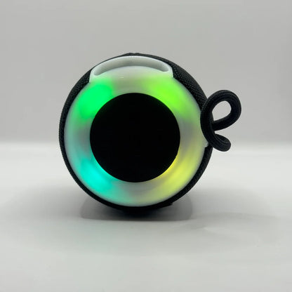 Top-down view of BLUK'S BX-176 wireless speaker showing vibrant illuminated multi-color RGB light ring
