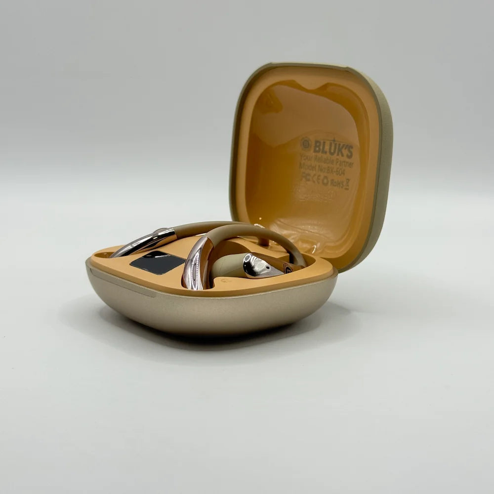 Front perspective view of Bluk's BX-604 ear-hook earbuds seated in gold charging case
