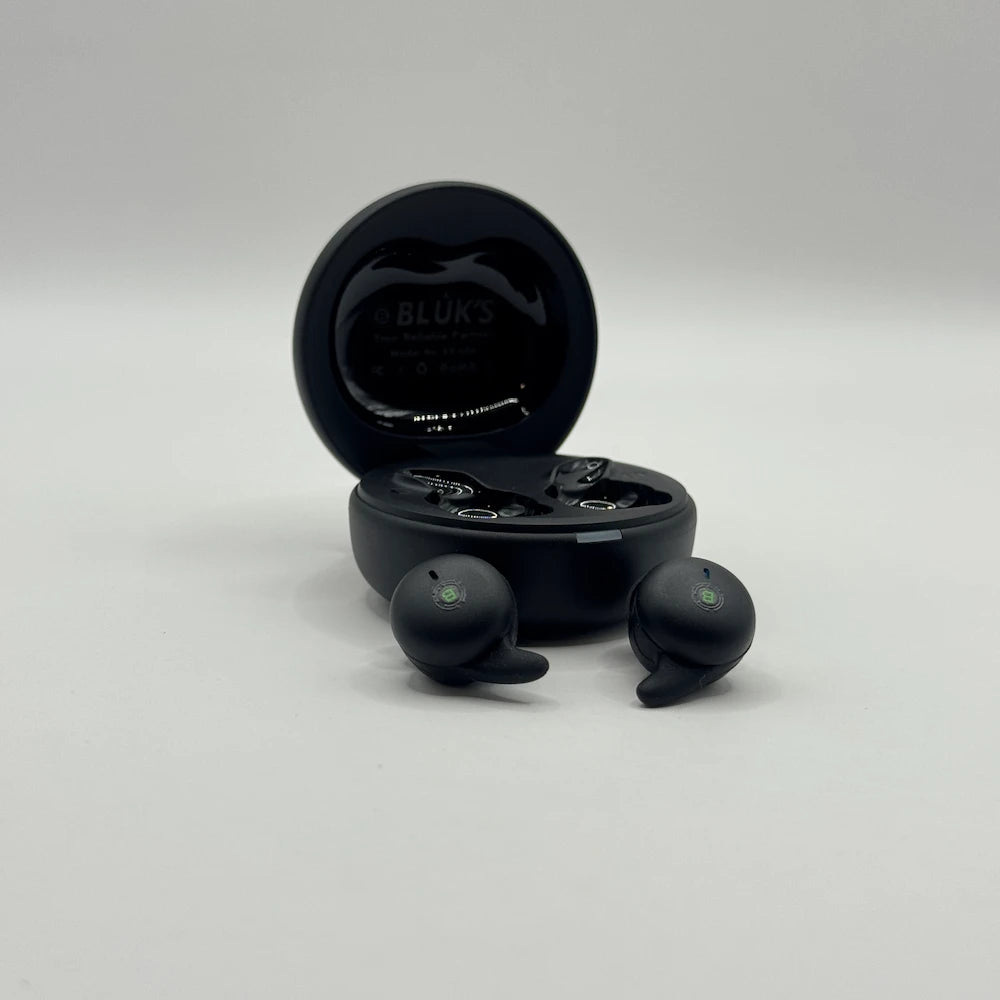 BLUK'S BX-606 wireless earbuds placed outside open black charging case showing ear-fin design and brand logo