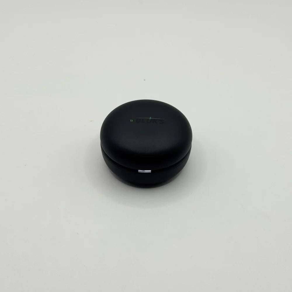 Top view of closed round matte black BLUK'S BX-606 wireless earbuds charging case with LED indicator