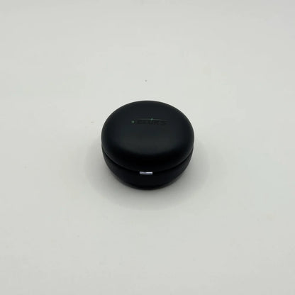 Top view of closed round matte black BLUK'S BX-606 wireless earbuds charging case with LED indicator