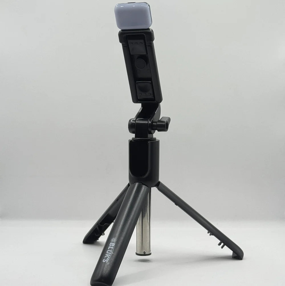 Bluk's BX310 black selfie stick tripod set up in standing position with top LED fill light attachment
