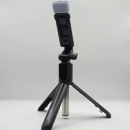 Bluk's BX310 black selfie stick tripod set up in standing position with top LED fill light attachment