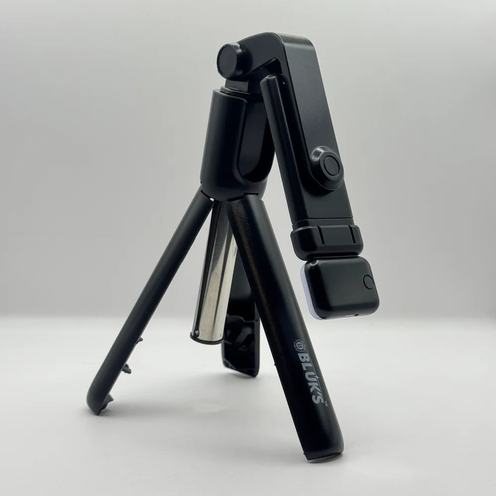 Close up view of Bluk's BX310 folded lightweight selfie stick tripod showing brand logo and compact design