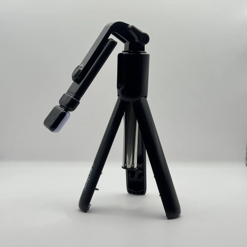 Side perspective of Bluk's BX310 black mini tripod stand with adjustable phone holder mount