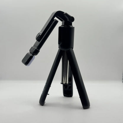 Side perspective of Bluk's BX310 black mini tripod stand with adjustable phone holder mount