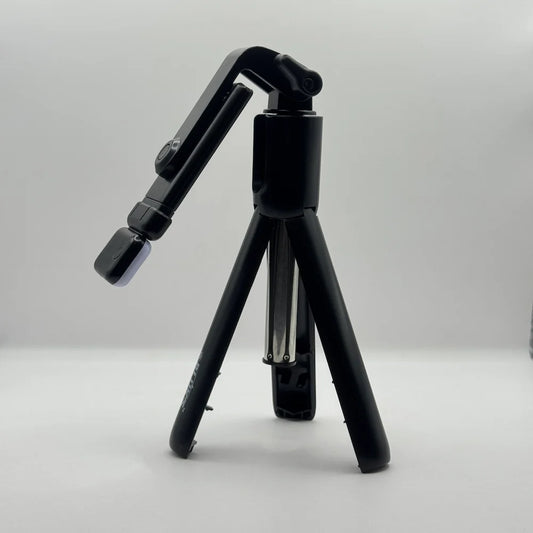 Side perspective of Bluk's BX310 black mini tripod stand with adjustable phone holder mount