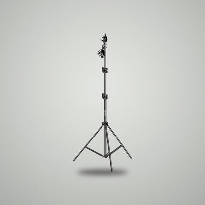 Full height view of BLUK'S black metallic adjustable studio light stand with power cable attached