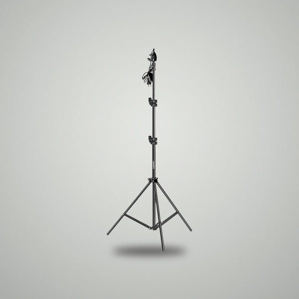 Full height view of BLUK'S black metallic adjustable studio light stand with power cable attached