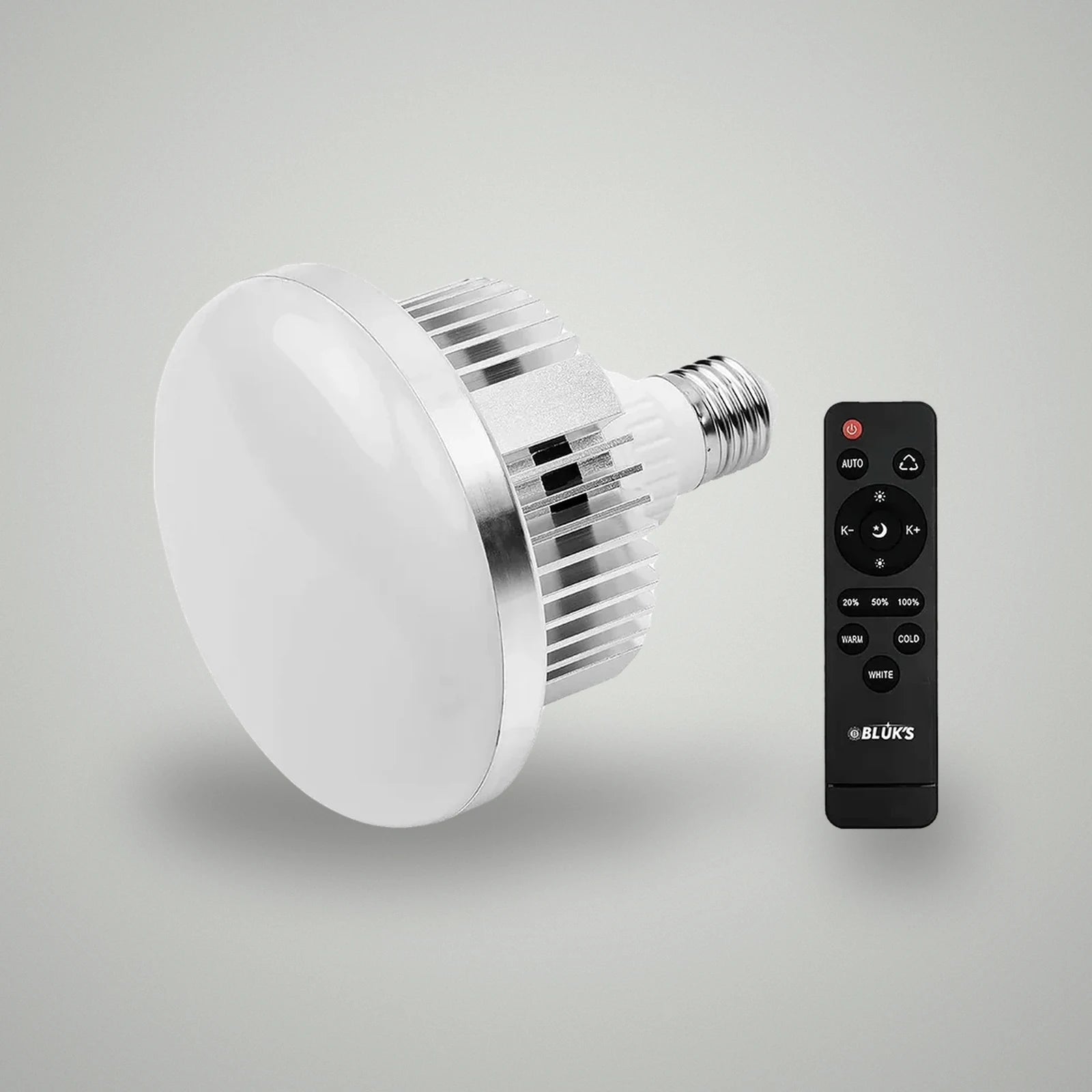 Perspective view of BLUK'S E27 studio LED light bulb alongside black wireless remote controller