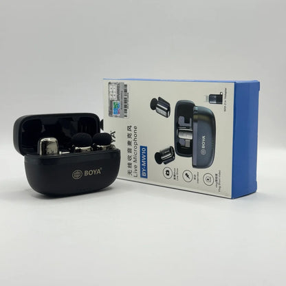 Open charging case revealing BOYA BY-MW10 wireless microphones next to product box displaying vlogging features