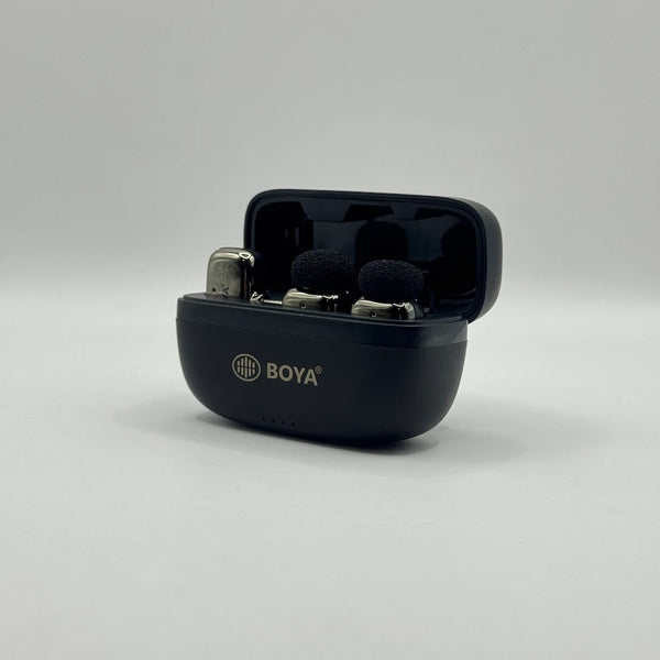 Front perspective view of opened BOYA BY-MW10 charging case with dual clip-on microphones docked inside