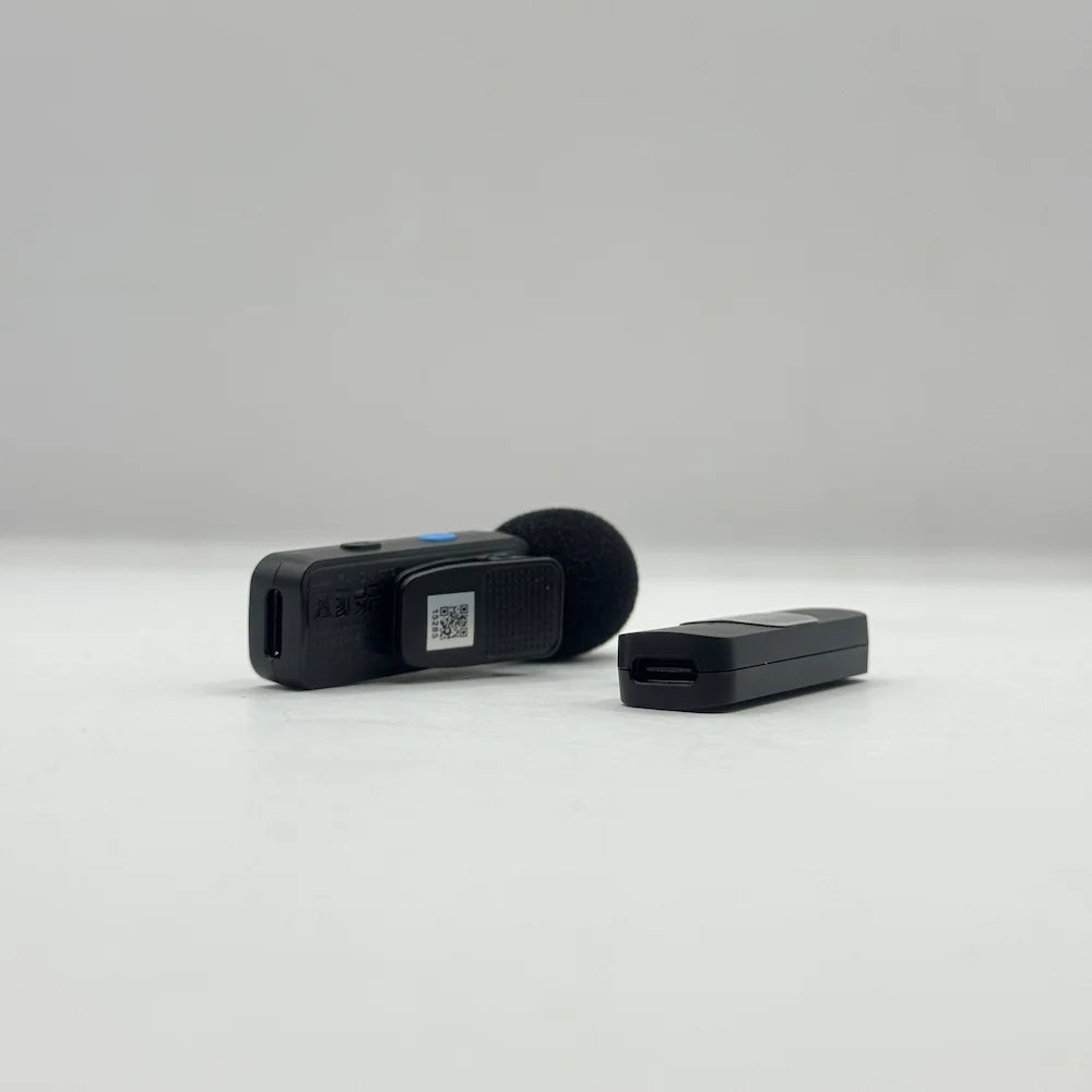 Side angle of BOYA BY-V1 transmitter clip and pass-through Type-C charging port on the Lightning receiver