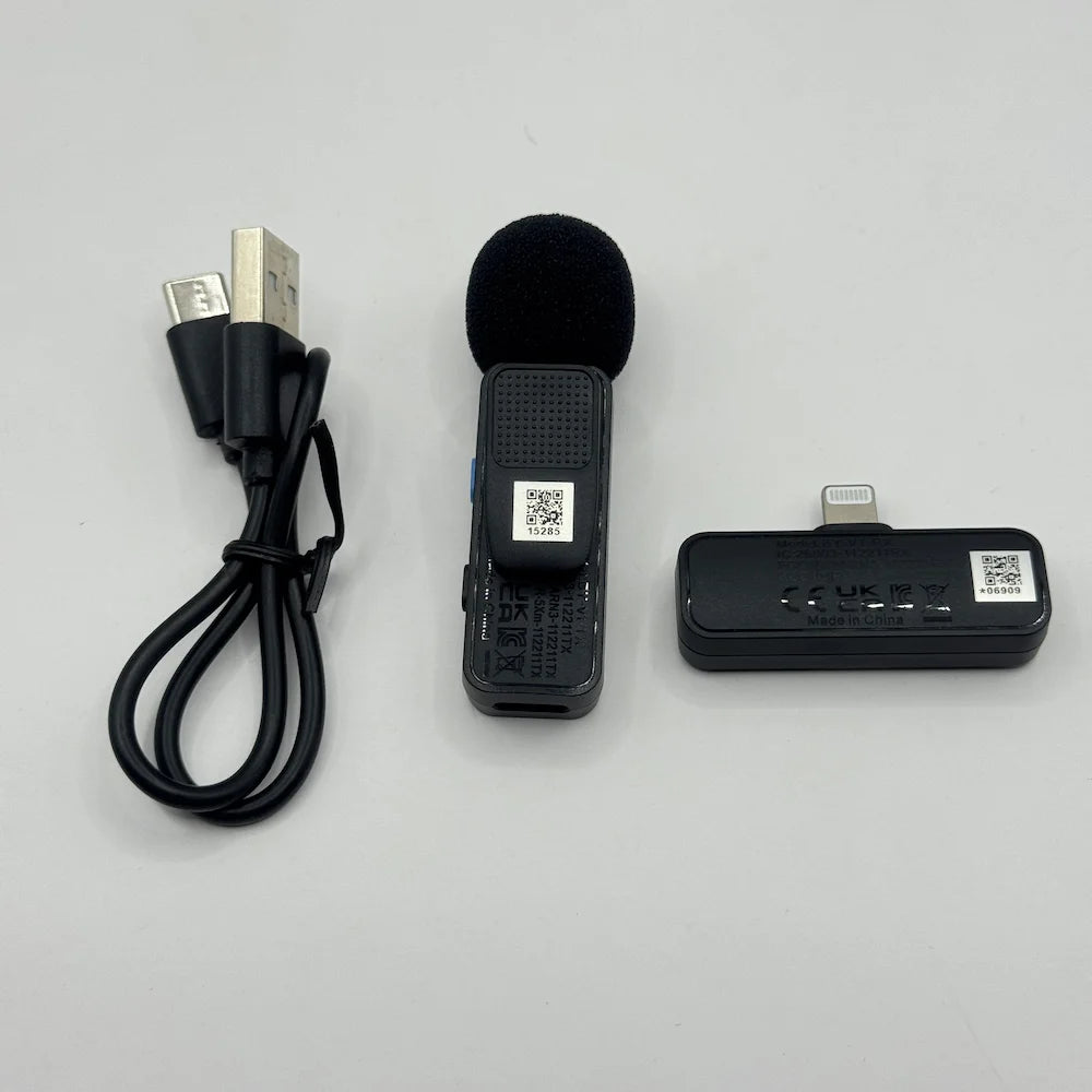 Front alignment of BOYA BY-V1 mic transmitter with foam windscreen, Lightning receiver unit, and USB charging cable