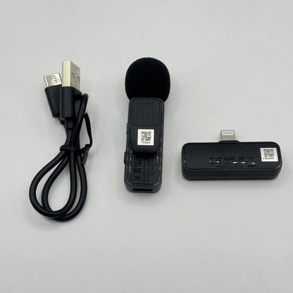 Front alignment of BOYA BY-V1 mic transmitter with foam windscreen, Lightning receiver unit, and USB charging cable
