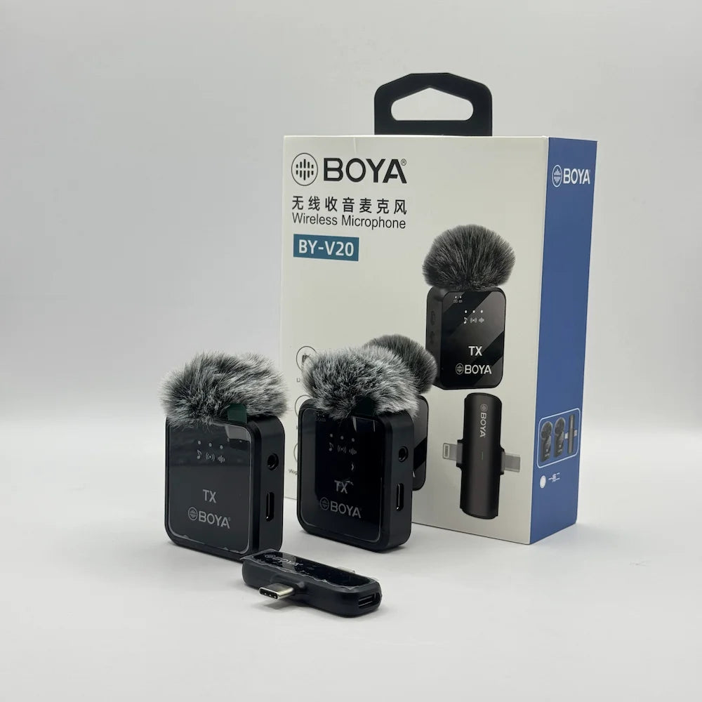 BY-V20 dual wireless microphone transmitters with furry deadcat windscreens and receiver sitting in front of retail packaging box