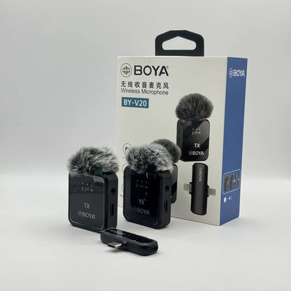 BY-V20 dual wireless microphone transmitters with furry deadcat windscreens and receiver sitting in front of retail packaging box