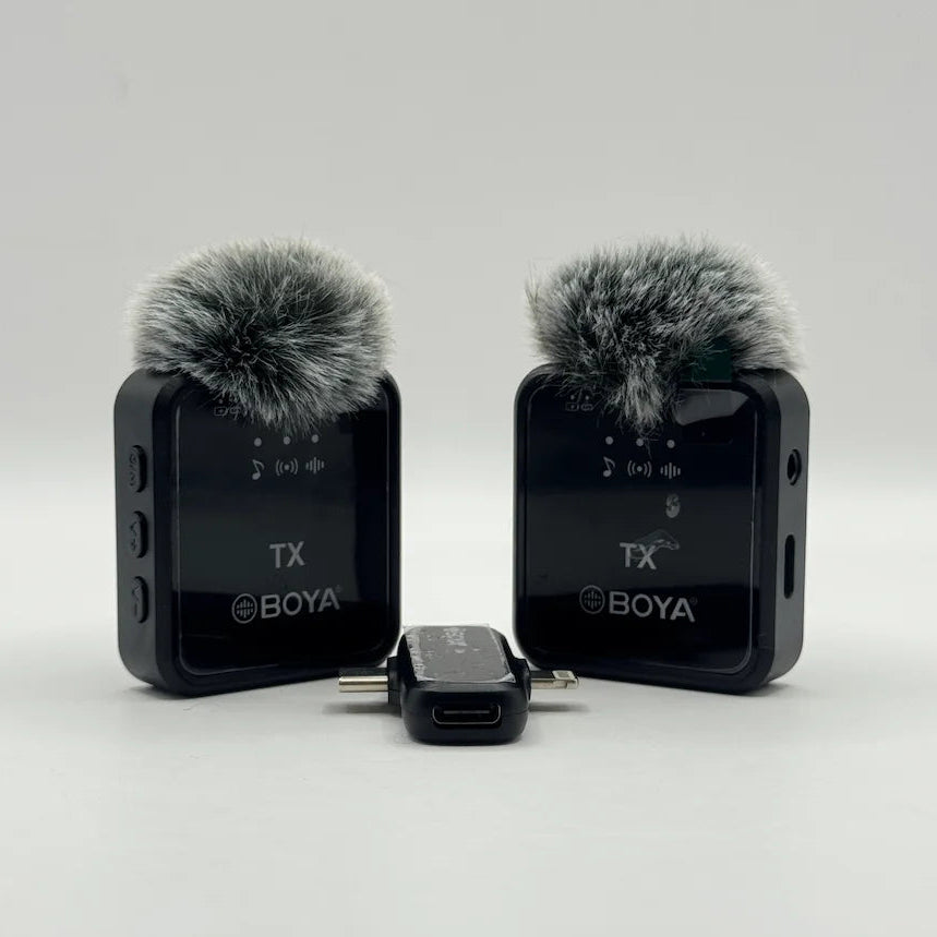 Frontal view of twin BY-V20 wireless transmitter units with furry windscreens and dual plug receiver adapter