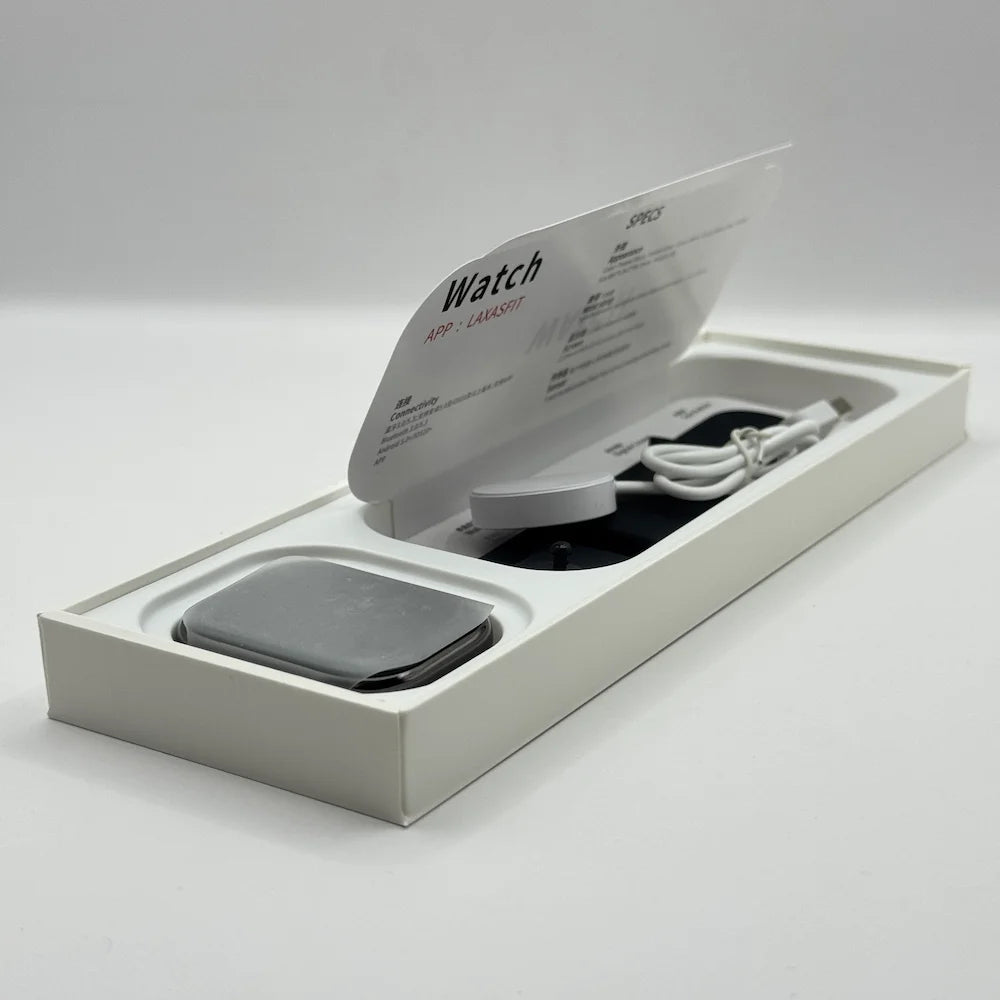 Inside view of unboxed Laxasfit Watch 10 Max package showing the smartwatch dial, manual, and charging cable tray