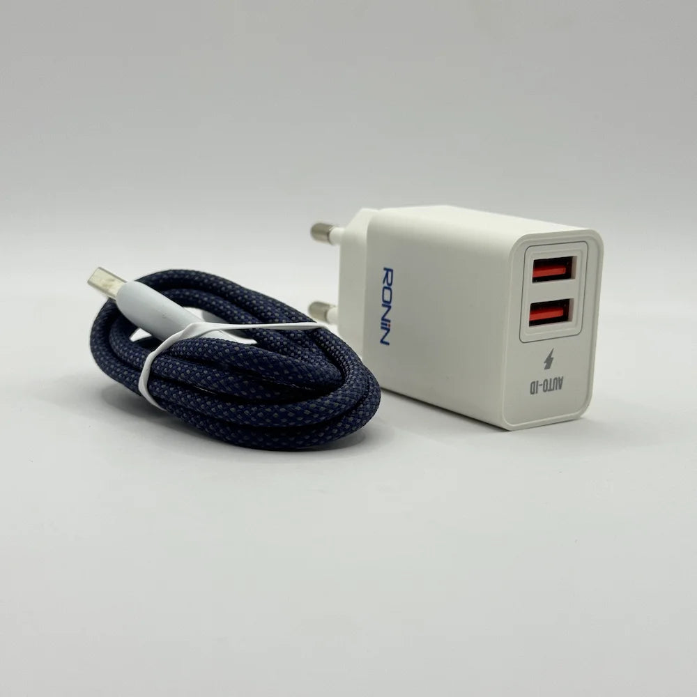 Side angle of Ronin R-615 Encore 2.4A dual USB adapter sitting next to coiled dark blue braided cable