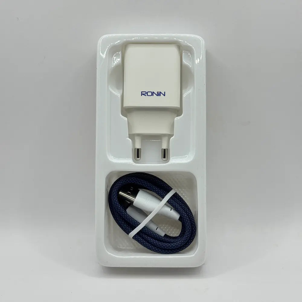Ronin R-615 Encore white power adapter and blue braided Lightning cable placed in inner plastic packaging tray