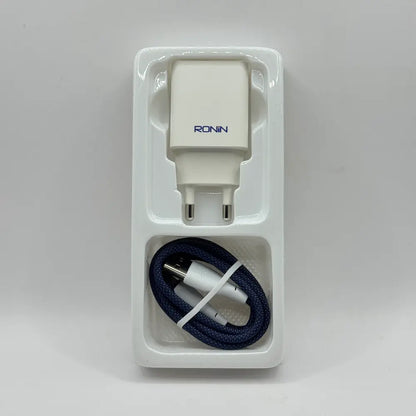 Ronin R-615 Encore white power adapter and blue braided Lightning cable placed in inner plastic packaging tray