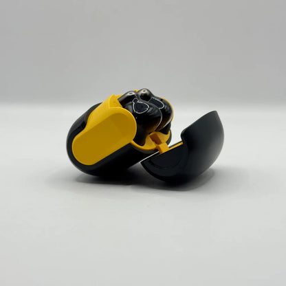 Side angle perspective of U39 wireless bluetooth earbuds stored in open yellow inner charging case